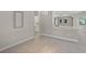 Open-concept space featuring a kitchen with white cabinets, bar seating and a comfortable living area at 5354 Nathaniel Pl, Sarasota, FL 34233