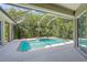 Screened-in outdoor pool area surrounded by lush foliage at 5354 Nathaniel Pl, Sarasota, FL 34233