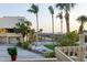 View from a balcony of a grassy backyard with a white picket fence overlooking beach and ocean at 540 Beach Rd # 510, Sarasota, FL 34242
