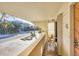 Balcony view facing beach neighborhood with outdoor chairs and tropical trees at 540 Beach Rd # 510, Sarasota, FL 34242