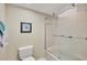 Bathroom featuring tiled shower and tub with a framed shower door and white toilet at 540 Beach Rd # 510, Sarasota, FL 34242