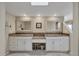 Spacious bathroom with double vanities, granite countertops, and elegant white cabinetry at 540 Beach Rd # 510, Sarasota, FL 34242