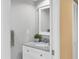 Half-bathroom featuring a granite countertop and sink, accompanied by a white vanity at 540 Beach Rd # 510, Sarasota, FL 34242