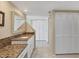 Well-lit bathroom with granite countertops, ample storage, and a clean, modern design at 540 Beach Rd # 510, Sarasota, FL 34242