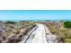 Picturesque sandy path lined with vegetation, leading to a serene beach at 540 Beach Rd # 510, Sarasota, FL 34242