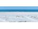Picturesque white sandy beach with calm, clear blue water and a few people enjoying the scenery at 540 Beach Rd # 510, Sarasota, FL 34242
