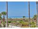 Gorgeous beach view framed by palm trees, showcasing the beautiful ocean and sandy shoreline at 540 Beach Rd # 510, Sarasota, FL 34242