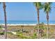 Stunning view of a beautiful beach with soft sand and clear water framed by tall palm trees at 540 Beach Rd # 510, Sarasota, FL 34242