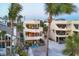 Beachfront home with balconies, outdoor seating, and lush tropical landscaping at 540 Beach Rd # 510, Sarasota, FL 34242