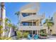 Stunning three-story beach home with balconies, lush landscaping, and inviting outdoor seating at 540 Beach Rd # 510, Sarasota, FL 34242