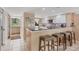 Kitchen featuring a breakfast bar, modern appliances, and ample counter space at 540 Beach Rd # 510, Sarasota, FL 34242