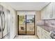 Modern kitchen showcasing white cabinetry, a stainless steel fridge, and granite countertops at 540 Beach Rd # 510, Sarasota, FL 34242