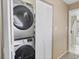 Hallway laundry area with a side-by-side washer and dryer and a bi-fold closet for storage at 540 Beach Rd # 510, Sarasota, FL 34242