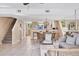 Bright living room with open floor plan, dining area, tile floors, and ocean view at 540 Beach Rd # 510, Sarasota, FL 34242