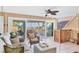 Bright living room with tile floors, ceiling fans, and sliding glass doors leading to an outdoor patio with an ocean view at 540 Beach Rd # 510, Sarasota, FL 34242