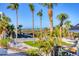 Picturesque view of a tropical beach, palm trees, and manicured lawn from the property at 540 Beach Rd # 510, Sarasota, FL 34242