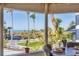 Panoramic view of a pristine beach with swaying palm trees visible from the outdoor dining table at 540 Beach Rd # 510, Sarasota, FL 34242