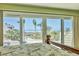 Breathtaking beach and palm tree views through sliding glass doors from the main bedroom at 540 Beach Rd # 510, Sarasota, FL 34242