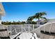 This relaxing balcony offers seating and lovely views of palm trees at 541 Fore Dr, Bradenton, FL 34208