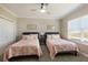 Bedroom with two beds, neutral color palette, and natural light at 541 Fore Dr, Bradenton, FL 34208