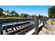 Waterfront home featuring a dock and boat lift with lush tropical landscaping and picturesque water views at 541 Fore Dr, Bradenton, FL 34208