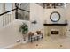 Bright foyer featuring a staircase, fireplace with mantle, and decorative elements creating a welcoming atmosphere at 541 Fore Dr, Bradenton, FL 34208