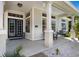 Inviting front porch showcasing a cozy porch swing, elegant columns, and stylish details, enhancing the home's curb appeal at 541 Fore Dr, Bradenton, FL 34208