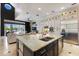 An open-concept kitchen with a large island, stainless steel appliances, and views of the living area at 541 Fore Dr, Bradenton, FL 34208
