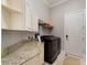Well-organized laundry room with ample counter space, cabinets, and a modern washer/dryer set at 541 Fore Dr, Bradenton, FL 34208