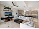 Open concept living room with modern decor, large sofa, TV, and seamless flow into the kitchen, perfect for entertaining at 541 Fore Dr, Bradenton, FL 34208