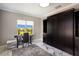 Bright office with a large black cabinet, desk, chair, and a window overlooking a lovely green view at 541 Fore Dr, Bradenton, FL 34208