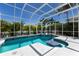 A private, screened-in pool area with a spa and ample space for entertaining at 541 Fore Dr, Bradenton, FL 34208