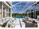 Screened-in pool area featuring a swimming pool, hot tub, and comfortable lounge seating for ultimate relaxation and enjoyment at 541 Fore Dr, Bradenton, FL 34208