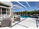 Relaxing screened pool area with outdoor lounge seating, offering a private tropical oasis at 541 Fore Dr, Bradenton, FL 34208