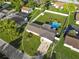 Aerial view of home featuring a spacious backyard with a pool, seating area, and white perimeter fence at 5524 25Th W St, Bradenton, FL 34207