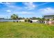 Expansive backyard featuring lush lawn and mature trees, providing privacy and ample outdoor space at 5524 25Th W St, Bradenton, FL 34207
