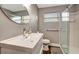 Bathroom featuring a large white sink, oval mirror and glass enclosed walk in shower at 5524 25Th W St, Bradenton, FL 34207