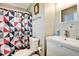 Well-lit bathroom showcases a modern sink, toilet, and uniquely patterned shower curtain at 5524 25Th W St, Bradenton, FL 34207