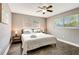 Serene bedroom with ceiling fan, two windows, and bedside lamps for a relaxing retreat at 5524 25Th W St, Bradenton, FL 34207