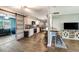 Bright kitchen and living area featuring bar seating, white cabinetry, stainless steel appliances, and barn-style doors at 5524 25Th W St, Bradenton, FL 34207