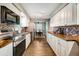 Bright kitchen boasts white cabinetry, stainless appliances, wood countertops, and mosaic backsplash at 5524 25Th W St, Bradenton, FL 34207