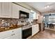 Charming kitchen features stainless steel appliances, mosaic backsplash, and warm wood countertops at 5524 25Th W St, Bradenton, FL 34207