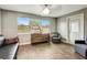 Bright living room with large windows, couch, wooden drawers, and a gray lounge chair at 5524 25Th W St, Bradenton, FL 34207