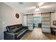 A living room featuring a sliding barn door, black sofa, and a view to the next room at 5524 25Th W St, Bradenton, FL 34207