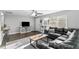 Cozy living room with modern furnishings, including a plush sofa, stylish rug, and a flat-screen TV at 5524 25Th W St, Bradenton, FL 34207