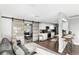 Open-concept living space featuring sliding barn doors, a modern kitchen, and bar-style seating at 5524 25Th W St, Bradenton, FL 34207
