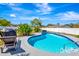 Beautiful backyard pool surrounded by landscaping and a lounge chair at 5524 25Th W St, Bradenton, FL 34207