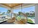Inviting balcony features egg chairs and a stunning waterfront view, perfect for relaxation at 560 Schooner Ln, Longboat Key, FL 34228
