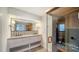 Bright bathroom features a dual sink vanity with designer backsplash and an enclosed sauna at 560 Schooner Ln, Longboat Key, FL 34228
