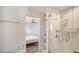 Modern bathroom with white tile shower and view into the bedroom, offering a luxurious and relaxing experience at 560 Schooner Ln, Longboat Key, FL 34228